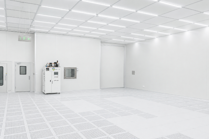 Completed modular biopharma cleanroom interior with sealed panels ceiling grid and raised floor
